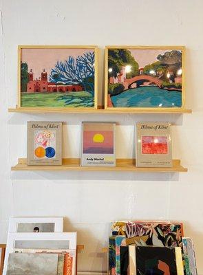 Original art, prints, and books are a staple here at the shop.