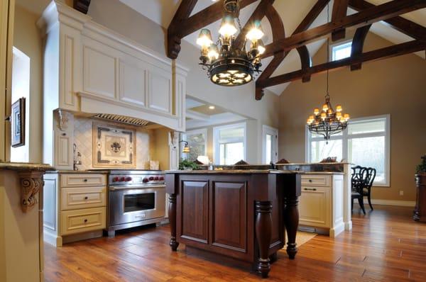 Traditional painted cabinetry with stained wood island.