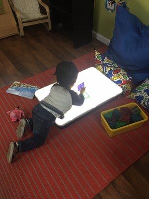 One of our kids playing in the light table.