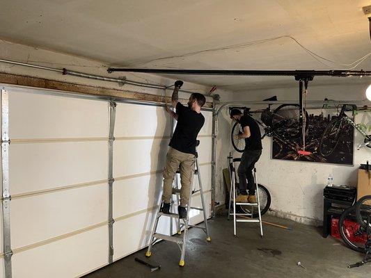 Ben and Rafael working to fix our garage door.