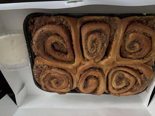 Cinnamon rolls with container of icing