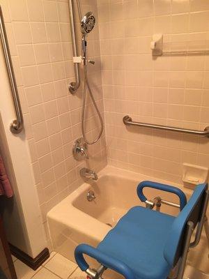 Grab bars added on tile ,bath transfer seat, shower  wand with holder for easy reach