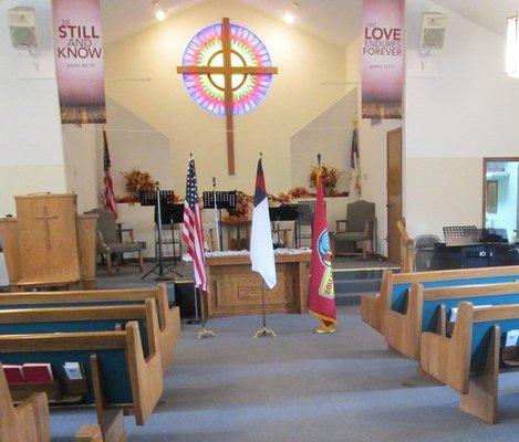 Some flags next in front of the cross replica