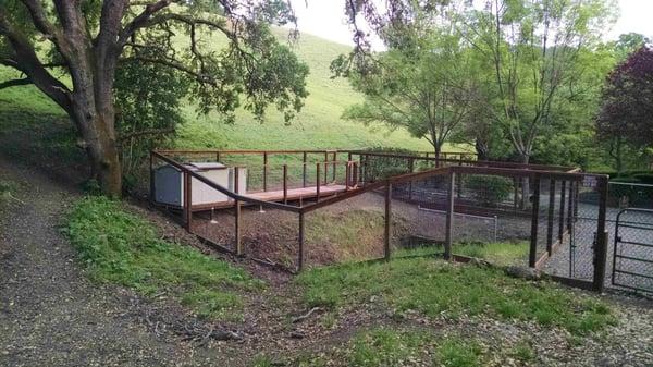 Dog pen with redwood deck built by Ken and his crew