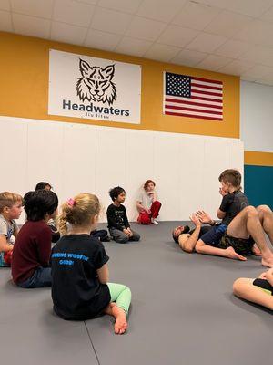 Kid's Jiu Jitsu class learning the technique for the day: Trap & Roll Mount Escape