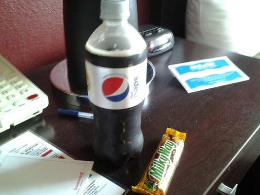 Here's a Milky Way Simulation: a diet soda next to a chocolate bar with yellow and brown, only to serve my hunger purposes with its gusto.