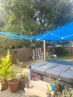 Installed shade sail over hot tub