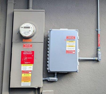 on left: pre-existing electrical service panel
 ?
 on right: Next Solar Inc's new panel and conduit, beautifully installed