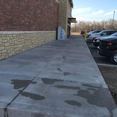 Pressure wash clean of building and sidewalks