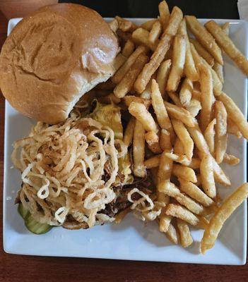 Pulled pork sandwich with crispy onions and melted cheddar, side of fries