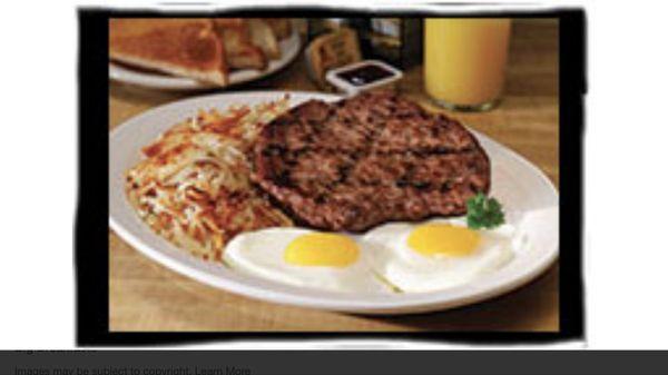 Chop steak Breakfast with hash browns and toast