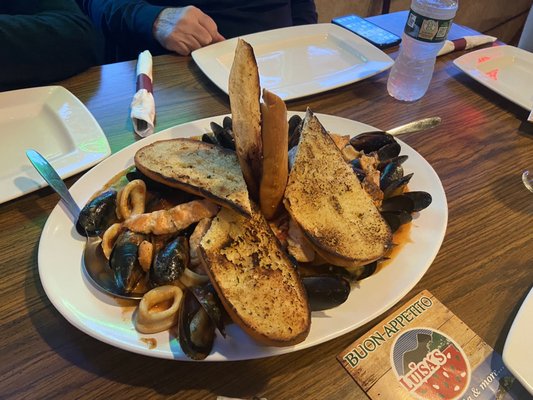 Zuppa de Pesce appetizer loaded with mussels, calamari, shrimp, salmon and scallops. Amazing!