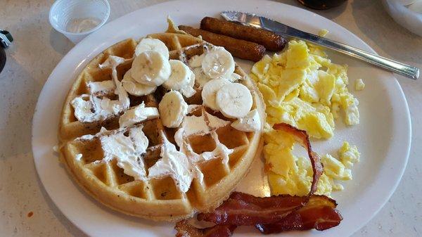 Hungry man breakfast with banana nut Belgian waffle.