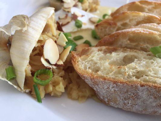 Roasted garlic, and Brie topped with toasted almonds and scallions. Grilled bread.