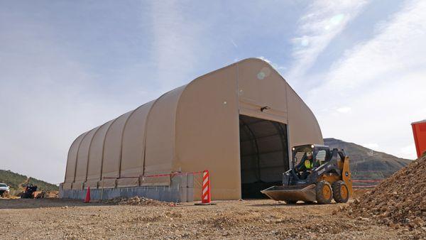 40' wide x 60' long fabric building on concrete foundation blocks from Alaska Structures for onsite vehicle maintenance facility.