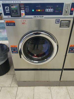 Handles 4 loads at once. Quarters and credit accepted. Price is $5.50 wash and .25/m for dryer.