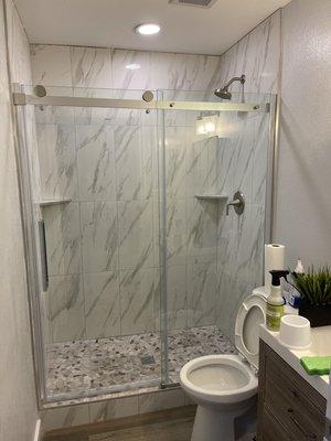 Tile, shower door installation, vanity, toilet installation, flooring, base trim, paint.