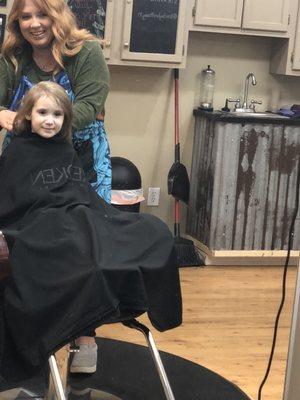 Brittany giving my daughter her first haircut.