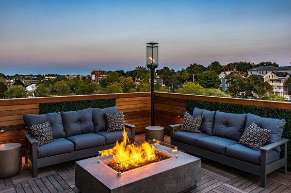 Rooftop deck fire pit area with seating.