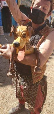 A puppeteer with his lifelike marionette pup.