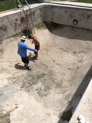 Packing the dirt down for concrete base.