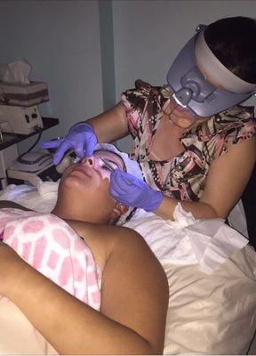 Teen facial, (performing extractions).