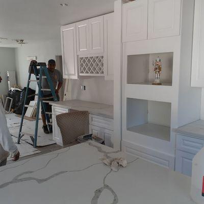 Cabinets being installed.  Countertops.quartz.whitecalacutta