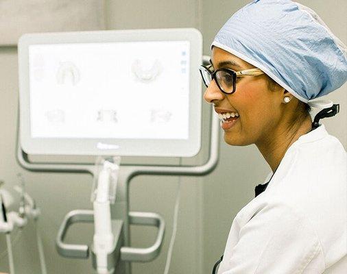 Dr. Marwa Forest smiling while talking to a patient.