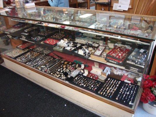 A large amount of vintage jewelry in the first display case (at the front desk checkout area).