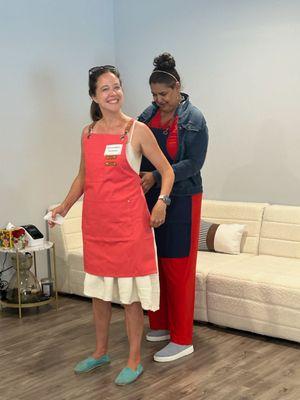 Student Betsy getting her apron on