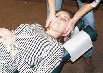 Chiropractor Mike Dumond performs a cervical spine adjustment to address neck pain and stiffness