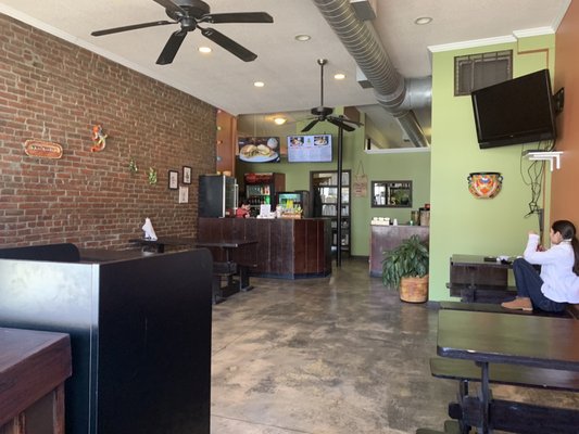 Small, but clean interior with picnic / farm table style seating and a couple bar counters by the front windows.