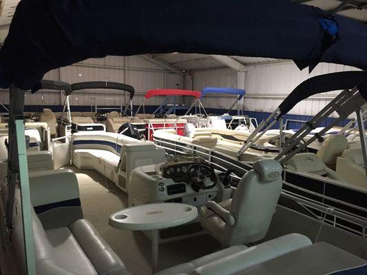 Photo of used pontoons in showroom at Wawasee Boat Company