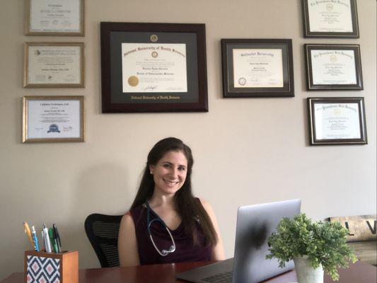 Dr. Christie in her office, ready to see patients virtually!