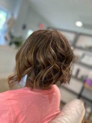 This look was a collaboration between Tabitha and Chelsey using a high light and low light technique and a curly cut styled out with an iron