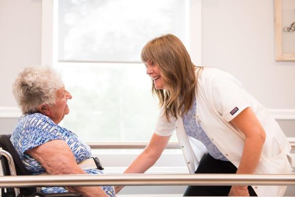 Lisa, Physical Therapist assisting a patient to stand using the Parallel bars.