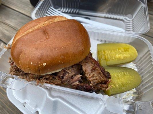 Brisket sandwich with a side of pickle