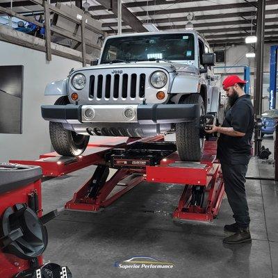 Dave getting ready to check the alignment on this Jeep Wrangler.