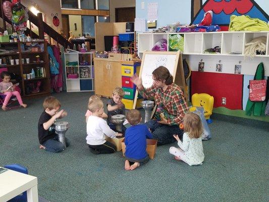 Teachers engage children with music and bongos