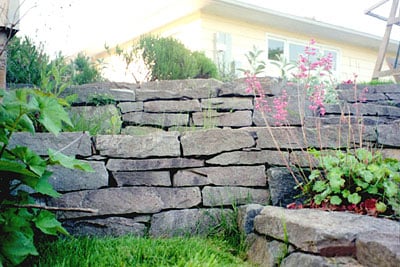 Dry laid split basalt stone wall.