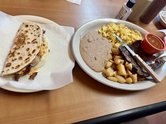 Steak and eggs with a bean and cheese with bacon