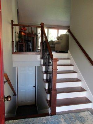 Half-walls between stairway and on landing were replaced by wrought iron railings. Particle board stairs replaced with hardwood.