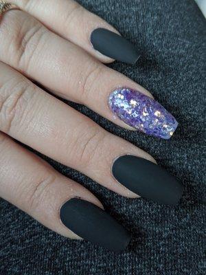 Matte black with purple glitter Ask for Peter, he has an amazing eye for the details and takes his time to get your nails perfect.