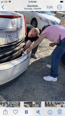 Robert and Connie trying to fix my wrecked vehicle