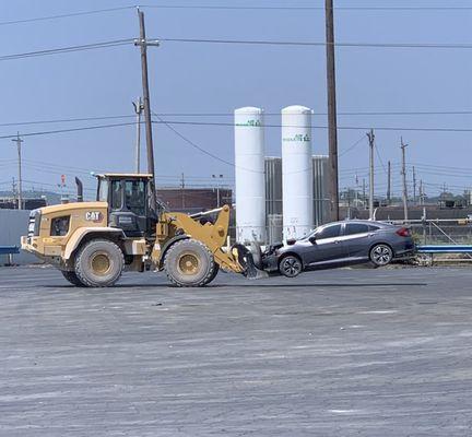 This is how they move the vehicles. There is a large tire on the front that the car sits against. That is what caused the damage.