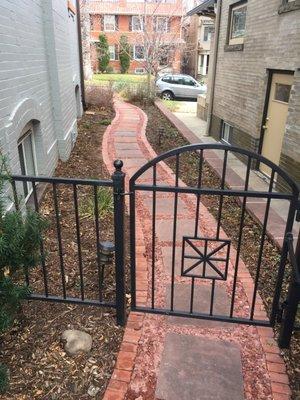 Front to backyard walkway. Brick border with Flagstone foot squares in a crushed stone surface embedded in colored concrete.