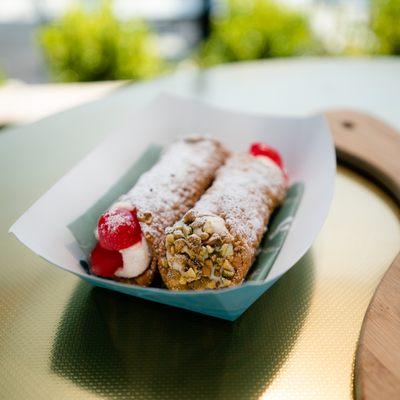 Crispy cannoli filled with creamy ricotta and finished with nuts and berries.