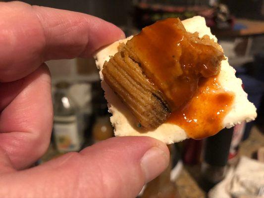 Hot tamale bite with hot sauce