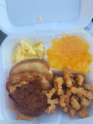 Scrambled eggs, cheese grits,  salmon pattie and fried counch strips.