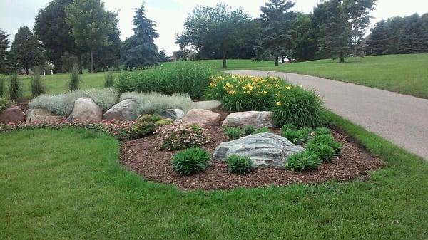 Decorative use of boulders in garden bed